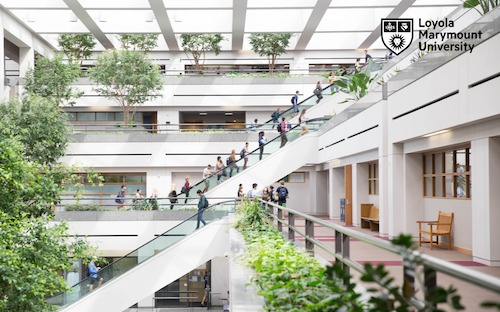Students/Faculty on escalator in University Hall on campus